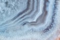 Close-up view of a fragment of white striped agate