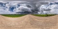 Full seamless spherical hdri panorama 360 degree angle view on no traffic gravel road among fields with overcast sky before storm Royalty Free Stock Photo