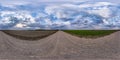 Full seamless spherical hdri panorama 360 degrees angle view on gravel road among fields in spring day with storm clouds before Royalty Free Stock Photo