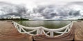 Full seamless spherical hdri panorama 360 degrees angle view on wooden pier for ships on huge lake in gray rain sky in