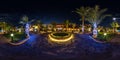 Full seamless spherical night hdr 360 panorama on territory of elite hotel with palm trees and neon lights in desert on shores of