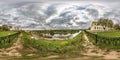 Full seamless spherical panorama 360 degrees angle view on bank of wide river in front of bridge in city center. 360 panorama in