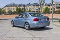 Full shot rear view BMW 320D blue. Urban scene.