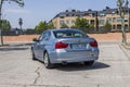 Full shot rear view BMW 320D blue. Urban scene.