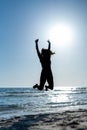 unrecognizable woman jumping at the seashore Royalty Free Stock Photo