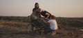 Wheelchaired soldier being together with family