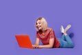 Full size body photo of young interested girl receive notification from dating website texting laptop isolated on purple Royalty Free Stock Photo