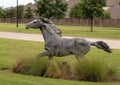 Full size bronze sculpture of a horse running beside a neighborhood in the Phillips Creek Ranch development in Frisco, Texas