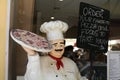 Pizza chef figure advertising take away food in Italy