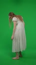 Full-size half turn vertical green screen, chroma key shot of a posessed female, woman figure, ghost, poltergeist