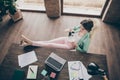 Full size high angle above view photo of beautiful business lady hold coffee mug resting house remote work legs on table