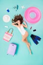 Full size high angle above view vertical flat lay photo of funky lady lying floor surrounded trip stuff things show v