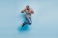 Full size photo of afro american guy jump cellphone isolated blue color background