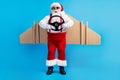 Full size photo of amazed fat santa claus with big belly grey beard controll steering whell fly wings x-mas christmas Royalty Free Stock Photo