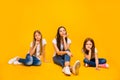 Full size photo of amazing three ladies sitting floor not interested in talk wear casual clothes isolated yellow