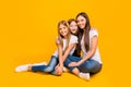 Full size photo of amazing three ladies sitting floor wear casual clothes isolated yellow background