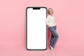 Full size photo of attractive senior woman vertical big smartphone screen eshop wear trendy white clothes isolated on