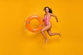 Full size photo of beautiful funny lady beach pool jumping into water lifeguard carry orange buoy save drowning person Royalty Free Stock Photo