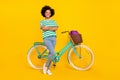 Full size photo of boss millennial lady near bicycle wear t-shirt jeans shoes bag isolated on yellow background Royalty Free Stock Photo