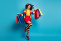 Full size photo of brown curly haired trendy stylish girl wear red skirt long striped socks rainbow sweater jump