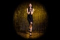 Full size photo of brown optimistic lady stand sing in mic wear black dress shoes isolated on dark gold color background Royalty Free Stock Photo