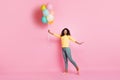 Full size photo of charming amazed african girl hold many balons flying in air present given for anniversary feel