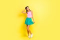 Full size photo of charming stunning young woman hold hair bottom green skirt summer isolated on yellow color background