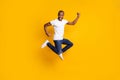 Full size photo of cheerful delighted afro american guy jump celebrate discount spring time win raise fists scream yes Royalty Free Stock Photo