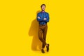 Full size photo of cheerful guy dressed striped shirt trousers arms folded look at offer empty space isolated on yellow