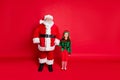 Full size photo of cheerful two santa and elf holding hands ready to enjoy newyear noel wearing bright green costume Royalty Free Stock Photo