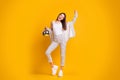 Full size photo of cheerful youth hold mirror ball glow glitter move wear casual clothes isolated over yellow background