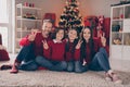 Full size photo of cool family boy girl sit comfort on carpet show v-sign wear red jumpers jeans socks christmas eve