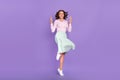 Full size photo of crazy millennial brunette lady jump show v-sign wear shirt skirt shoes isolated on purple background