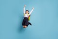 Full size photo of crazy school lady jump high classroom friends 1 september wear white shirt skirt suit isolated blue Royalty Free Stock Photo