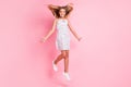 Full size photo of cute blond girl jumping wear white dress isolated on pastel pink color background Royalty Free Stock Photo