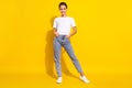 Full size photo of cute brown hairdo young lady stand wear white t-shirt jeans isolated on yellow color background Royalty Free Stock Photo