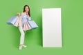 Full size photo of cute charming lady impressed to see promotion banner isolated on green color background Royalty Free Stock Photo