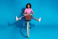 Full size photo of eccentric cereless woman wear pink shirt driving bicycle with flowers in bucket isolated on blue Royalty Free Stock Photo