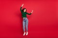 Full size photo of energetic cute girl dance success raise arms eyes closed dressed stylish green look isolated on shine