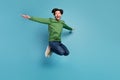 Full size photo of excited crazy cheerful man feeling freedom jumping in air isolated on blue color background Royalty Free Stock Photo