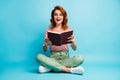 Full size photo of excited crazy woman nerd sit floor legs crossed read book impressed by story scream wow omg wear Royalty Free Stock Photo