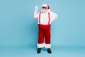 Full size photo of fat funky funny santa in hipster eyewear with funny big abdomen belly make v-sign enjoy christmas Royalty Free Stock Photo