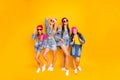 Full size photo of four beautiful pretty colorful fascinating having fun streetstyle fans teen youngsters wearing skirts Royalty Free Stock Photo
