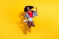 Full size photo of funky brown wavy haired afro american lady jump up make rock sign wear summer clothes isolated on Royalty Free Stock Photo