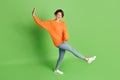 Full size photo of funky crazy young woman dance carefree good mood isolated on green color background