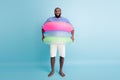 Full size photo of funky funny barefoot afro american guy enjoy weekend have colorful ring float lifesaver buoy ready