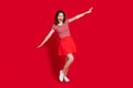 Full size photo of funny cute girl dancing youth party event spread harms wear top skirt gumshoes isolated red color Royalty Free Stock Photo