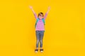 Full size photo of funny good mood pupil happy to go to school raising hands up in excitement on yellow color