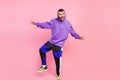 Full size photo of funny millennial brunet guy dance wear hoodie pants shoes isolated on pink color background
