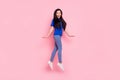 Full size photo of happy cheerful nice woman jump up walk good mood isolated on pastel pink color background